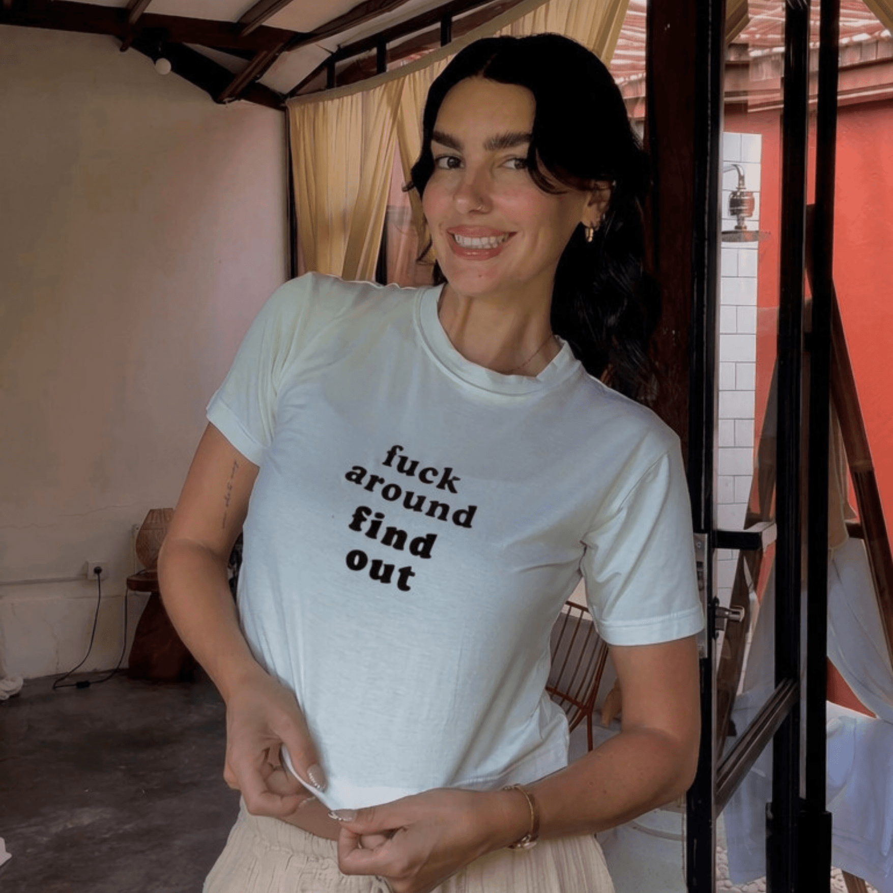 Shannon smiling in a white Soul Flow Wear graphic tee